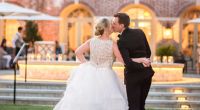 Bride and groom kiss in outdoor setting at Colonial Williamsburg