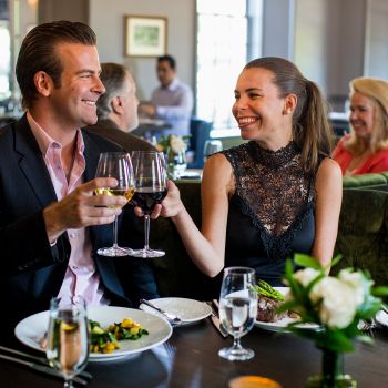 Couple toasting with wine glasses at a restaurant