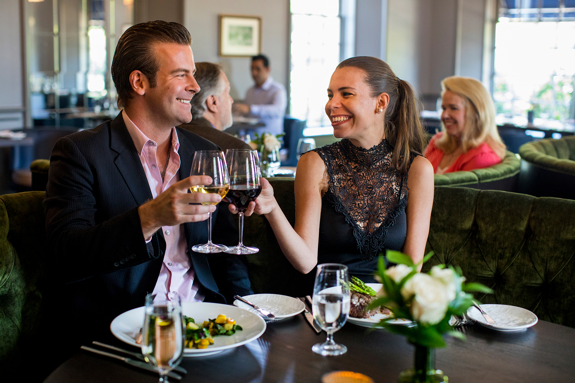 Couple toasting with wine glasses at a restaurant