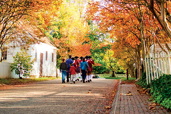 Group of patriots and children walking in the fall.